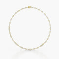 A delicate yellow gold tennis necklace with small round-cut diamonds, arranged in a circular shape against a clean white background.