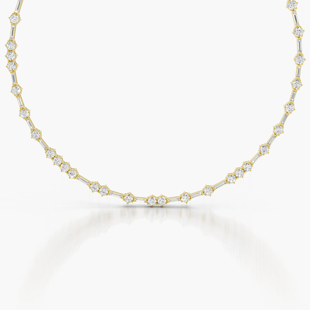 A delicate yellow gold tennis necklace featuring small round-cut clear gemstones set in gold, displayed against a clean white background with a soft reflection.