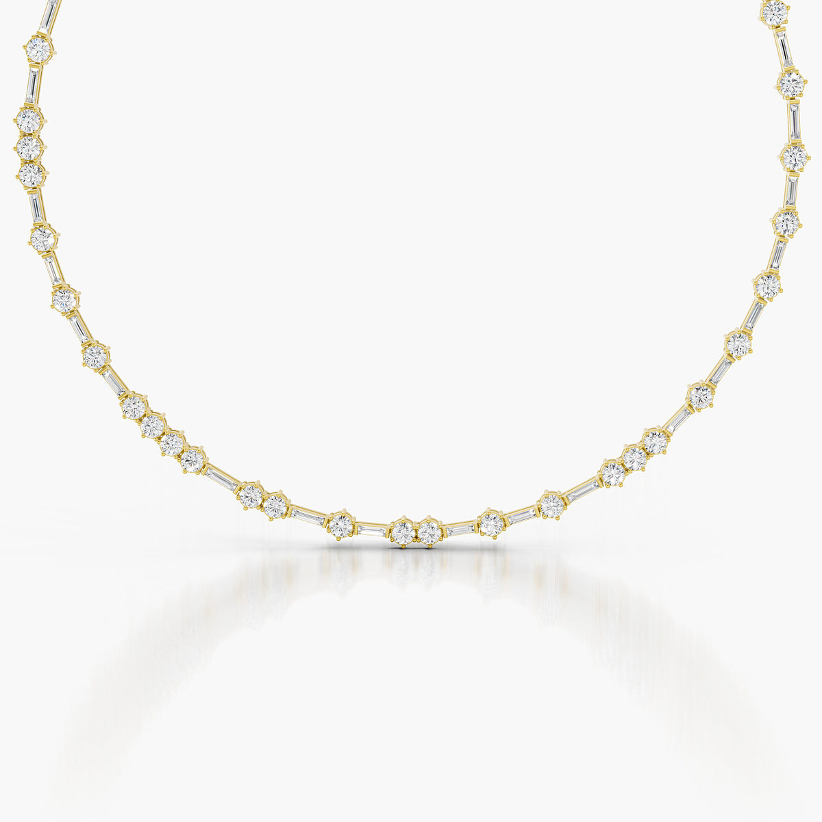 A delicate yellow gold tennis necklace featuring small round-cut clear gemstones set in gold, displayed against a clean white background with a soft reflection.